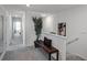 Hallway with neutral decor, bench seating, and view into a bedroom at 2688 Gouda Dr, Apopka, FL 32703