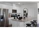 Bright kitchen with stainless steel appliances, granite countertops, and a breakfast bar at 2688 Gouda Dr, Apopka, FL 32703