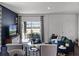 Well-lit living room features modern furniture and a sliding glass door to an outdoor seating area at 2688 Gouda Dr, Apopka, FL 32703