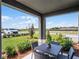 Cozy covered patio featuring outdoor seating with a view of the well-manicured front yard at 2688 Gouda Dr, Apopka, FL 32703
