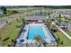 Aerial shot of a community pool featuring blue lounge chairs and umbrellas at 2688 Gouda Dr, Apopka, FL 32703