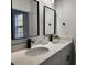 Bright bathroom featuring double sinks, black hardware, and modern fixtures at 2693 Sw 153Rd Place Rd, Ocala, FL 34473