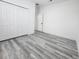 Bedroom with double door closet and gray toned wood flooring at 2693 Sw 153Rd Place Rd, Ocala, FL 34473