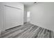 Bedroom with double door closet and gray toned wood flooring at 2693 Sw 153Rd Place Rd, Ocala, FL 34473
