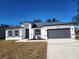 Charming single-story home with a gray roof, a two-car garage, and a well-manicured front yard at 2693 Sw 153Rd Place Rd, Ocala, FL 34473