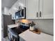Modern kitchen featuring stainless steel appliances, white cabinets, sleek countertops, and stylish decor at 2693 Sw 153Rd Place Rd, Ocala, FL 34473