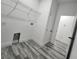 Bright laundry room features gray wood-look flooring and a wire rack for storage at 2693 Sw 153Rd Place Rd, Ocala, FL 34473