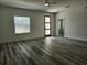 Bright living room featuring hardwood floors, a front door with glass inserts, and a ceiling fan at 2693 Sw 153Rd Place Rd, Ocala, FL 34473