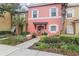 Charming two-story townhome with colorful exterior, lush landscaping, and welcoming front entrance at 2747 Sun Key Pl, Kissimmee, FL 34747