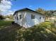 Back exterior of the property showing the white siding, windows, and well-maintained lawn at 2818 Geoffrey Dr, Orlando, FL 32826