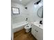 Bathroom with updated fixtures, bathtub, and marble tile at 2818 Geoffrey Dr, Orlando, FL 32826