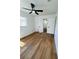 Spacious bedroom featuring modern ceiling fan, new wood flooring, and convenient access to an ensuite bathroom at 2818 Geoffrey Dr, Orlando, FL 32826