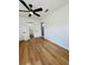 Spacious bedroom featuring modern ceiling fan, new wood flooring, and convenient access to an ensuite bathroom at 2818 Geoffrey Dr, Orlando, FL 32826