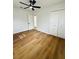 Bright bedroom features updated ceiling fan, wood-look floors, and closet at 2818 Geoffrey Dr, Orlando, FL 32826