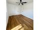 Spacious bedroom featuring modern ceiling fan, new wood flooring, and convenient access to an ensuite bathroom at 2818 Geoffrey Dr, Orlando, FL 32826
