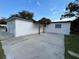 Rear exterior view of the house featuring a concrete patio at 2818 Geoffrey Dr, Orlando, FL 32826