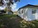 Exterior of the home with a well-maintained yard and storage shed in the background at 2818 Geoffrey Dr, Orlando, FL 32826