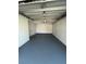 Spacious garage with a freshly painted floor and walls providing ample room for vehicles and storage at 2818 Geoffrey Dr, Orlando, FL 32826