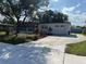 Home exterior showcasing garage, landscaping, and ample driveway space at 2818 Geoffrey Dr, Orlando, FL 32826
