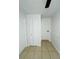 Bright hallway featuring neutral tile floors and white doors, offering a clean, modern aesthetic at 2818 Geoffrey Dr, Orlando, FL 32826