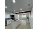 Open kitchen and living area featuring a center island, granite countertops, and modern fixtures at 2818 Geoffrey Dr, Orlando, FL 32826