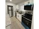 Modern kitchen featuring stainless steel appliances, granite countertops, and white cabinets, perfect for cooking at 2818 Geoffrey Dr, Orlando, FL 32826
