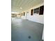 View of a covered porch with a blue door, wooden shutters, and a smooth gray floor surface at 2818 Geoffrey Dr, Orlando, FL 32826