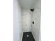 Modern shower with striking black and white tiling, rainfall showerhead, and updated fixtures at 2818 Geoffrey Dr, Orlando, FL 32826
