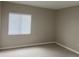 Bedroom showcasing neutral walls, carpet, and a large window with blinds for natural light at 314 Cherokee Ct # A, Altamonte Springs, FL 32701