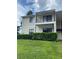Two-story condo featuring a second-story balcony with painted siding and well-maintained green space at 314 Cherokee Ct # A, Altamonte Springs, FL 32701