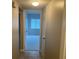 Hallway with tile flooring leading to a bedroom with neutral carpet and blinds at 314 Cherokee Ct # A, Altamonte Springs, FL 32701