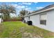 View of the backyard showcasing the exterior of the home with lush lawn at 3733 Pyrite Dr, Orlando, FL 32826