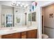 Bathroom featuring double sinks, a large mirror, and access to the bedroom and shower at 3733 Pyrite Dr, Orlando, FL 32826