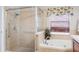 Well-lit bathroom showcasing a shower, bathtub, and a window with decorative valance at 3733 Pyrite Dr, Orlando, FL 32826