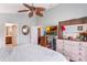 Bright bedroom featuring a ceiling fan, a dresser, and a TV with a tropical theme at 3733 Pyrite Dr, Orlando, FL 32826