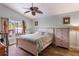 Comfortable bedroom featuring a ceiling fan and a sliding glass door to the outdoor patio at 3733 Pyrite Dr, Orlando, FL 32826
