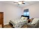 Cozy bedroom featuring a bed, a ceiling fan, and a small loveseat at 3733 Pyrite Dr, Orlando, FL 32826