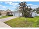 Well-maintained home with a paved driveway and lush green lawn, offering great curb appeal at 3733 Pyrite Dr, Orlando, FL 32826