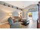 Bright living room with sliding door access to outdoor lanai and a cozy sitting area at 3733 Pyrite Dr, Orlando, FL 32826