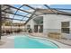 Backyard pool area featuring a screened-in enclosure and outdoor seating at 3733 Pyrite Dr, Orlando, FL 32826