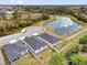 Aerial view of homes nestled in a serene neighborhood with a pond and lush greenery at 3771 Whitetail Ct, St Cloud, FL 34772