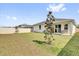 Spacious backyard featuring a well-manicured lawn, a patio, and lush landscaping at 3771 Whitetail Ct, St Cloud, FL 34772