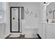Stylish bathroom with black hexagon floor tiles, a walk-in shower, and modern fixtures at 3771 Whitetail Ct, St Cloud, FL 34772