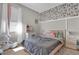 Cute bedroom with a large bed, plush carpet, and Mickey Mouse wallpaper accent wall at 3771 Whitetail Ct, St Cloud, FL 34772
