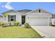 Charming single-story home with well-manicured lawn, two car garage, and neutral paint scheme at 3771 Whitetail Ct, St Cloud, FL 34772