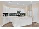 Modern kitchen with white cabinets, quartz countertops, a kitchen island, and designer backsplash at 3771 Whitetail Ct, St Cloud, FL 34772
