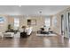 Spacious living room and dining area features hardwood floors, lots of light and neutral decor at 3771 Whitetail Ct, St Cloud, FL 34772
