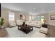 Bright living room featuring a tufted sofa, armchairs, modern decor, and lots of natural light at 3771 Whitetail Ct, St Cloud, FL 34772