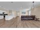 Open-concept living space with wood flooring connecting the kitchen and living area at 3771 Whitetail Ct, St Cloud, FL 34772