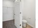 Toilet and walk-in closet in a well-lit bathroom at 4002 Copperleaf Ln, Poinciana, FL 34759